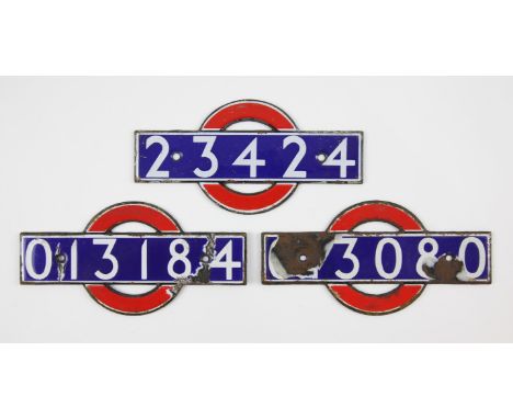 Set of London Underground enamel 'bull's eye' stock-number plates. Nos. 23424, ...3080 (badly damaged), 013184. (3). Provenan