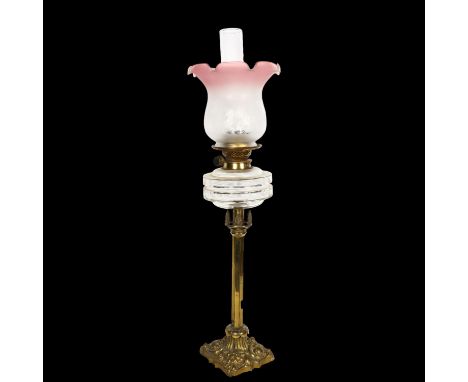 A Victorian embossed brass oil lamp, with glass font, chimney and etched glass shade, H74cm 