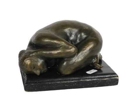 A bronzed ceramic sculpture, depicting a crouching nude, on wooden plinth, L18cm 