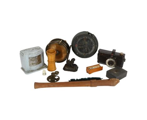 A military gimballed compass, ref no. 6A1672, fishing reel, a Ciney cast-iron money box in the form of a stove, Cinex Bakelit