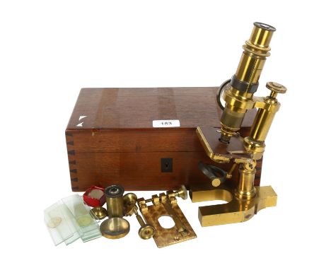 A Victorian brass student's microscope, various extra lenses and some glass slides, no maker's mark, in original fitted box, 