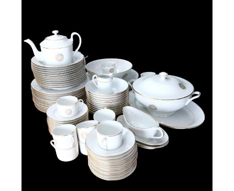 An extensive Limoges porcelain dinner service with gilded decoration and matching tea set, including teapot 