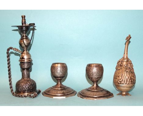 A Middle Eastern white metal nargile/hookah, 19.5cm high, a pair of short candlesticks and a table lighter, gross weight ___1