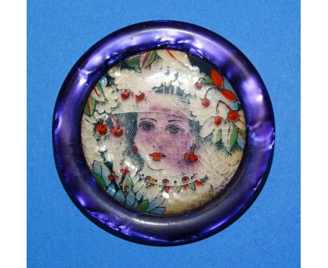 Léa Stein, Paris, a circular vintage serigraphy brooch c1960's depicting a lady wearing a hat, amongst foliage and cherries, 