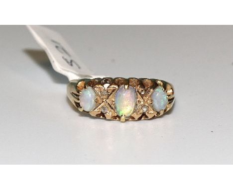 An 18ct gold three-stone opal ring, with rose-cut diamond points, (one diamond missing), size K, 3g. 