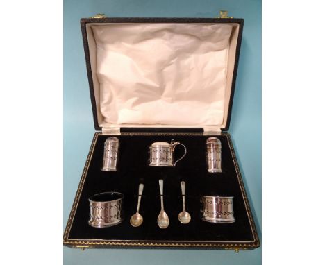 A five-piece silver cruet of cylindrical form with pierced decoration, each item with blue glass liner, with three spoons, Wi