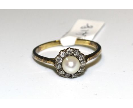 A diamond and pearl cluster ring set eleven old-cut diamonds around a cultured pearl, in 18ct gold mount, size R, 2.7g. 