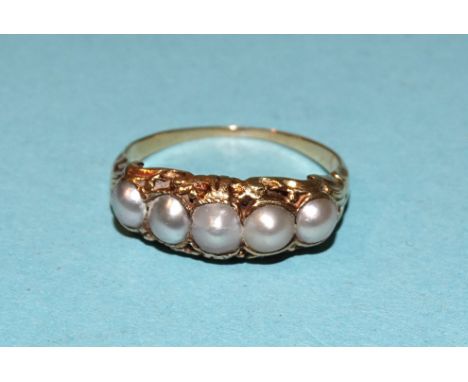 A Victorian gold ring set five graduated demi-pearls, unmarked, tests as 18ct, size K½, 3.3g. 