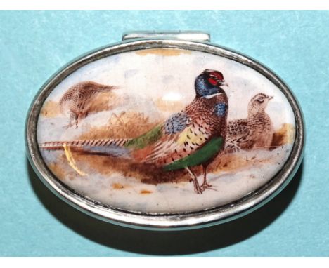 A modern oval pill box, the lid inset an enamelled image of a cock and hen pheasant, 4cm long, (boxed), two other 925-silver 