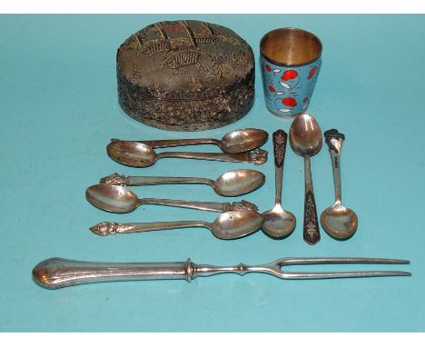 A large white metal-sided pin cushion, an enamelled tot beaker, eight coffee spoons marked 'Sterling' and a fork. 