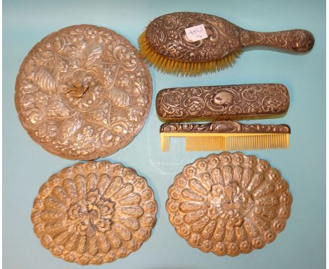 An Egyptian silver circular dressing table mirror surmounted by a peacock, 20cm, two others, similar and other dressing table