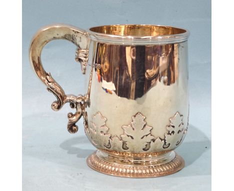 A silver tankard with applied leaf frieze and scroll handle, raised on gadrooned foot, Asprey &amp; Co. Ltd, London 1930, eng