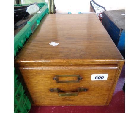 A vintage oak single filing drawer with brass handle and label holder