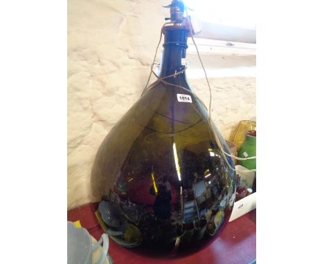 An early 19th Century large green carboy with later lamp conversion