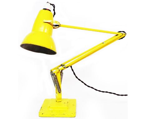 A vintage Herbert Terry Anglepoise lamp with original yellow painted finish and square stepped base