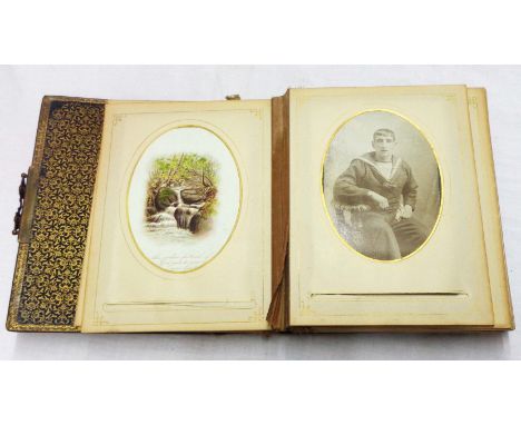 A late Victorian family photograph album containing posed single and group shots, antique greetings cards and a sketch of pip