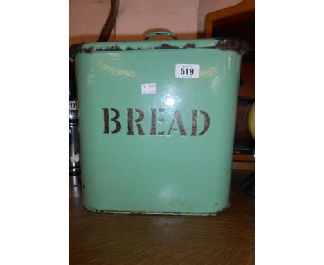 A vintage enamel bread bin with black lettering on a green ground