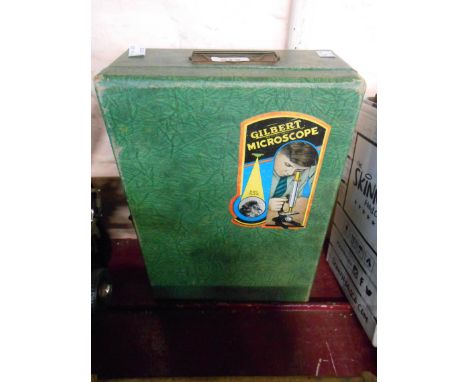 A vintage Gilbert child's microscope set in original carry case containing microscope, assorted sample tubes, slides, etc.