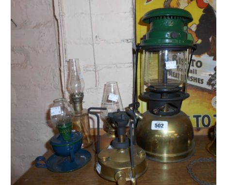 A vintage Tilley lamp sold with three small oil lamps and a primus style stove.