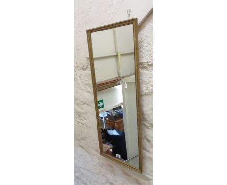 A gilt framed narrow oblong wall mirror