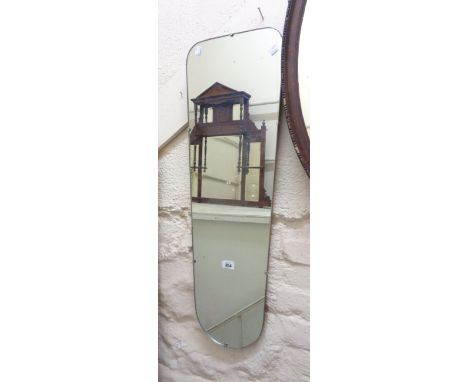 A retro frameless wall mirror with shaped tapered plate
