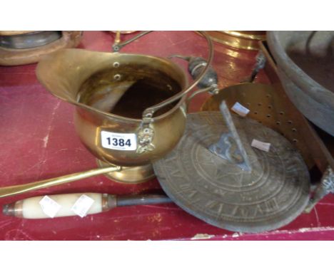 A small selection of assorted of metalware comprising sundial, brass skimmer, poker, etc.