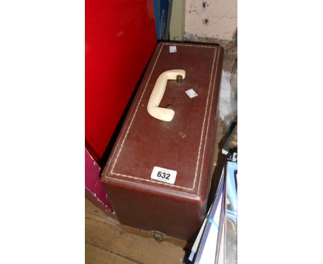 A vintage Singer sewing machine in original faux leather covered case