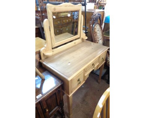 A 92cm stripped pine and mixed wood dressing table with swing mirror and three drawers, set on square legs