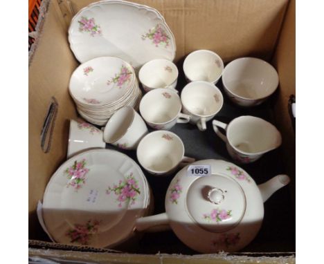 A box containing a Bovey Pottery tea set comprising teapot, milk and sugar, seven trios, bread and butter plate and spares