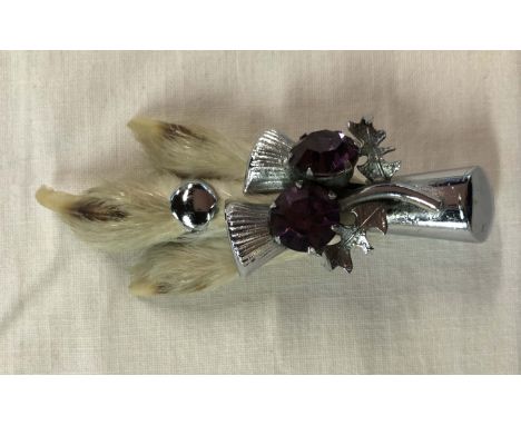 A vintage Scottish Ptarmigan foot brooch with chrome plated finish and inset amethyst glass stones