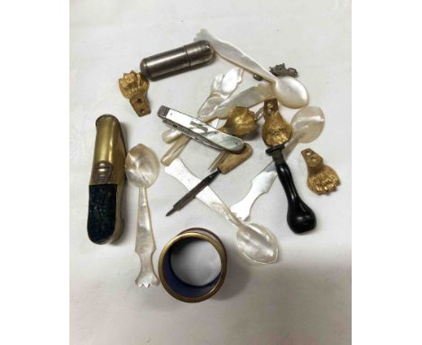 A selection of mother-of-pearl clad spoons, knives, brass shoe, etc.