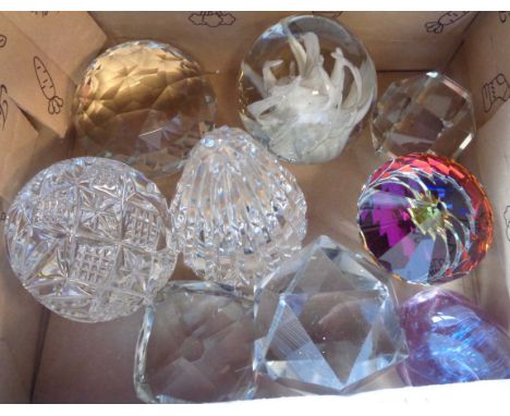 A box containing nine assorted glass paperweights including Liskeard Glass internal enamel example, Caithness similar and cut