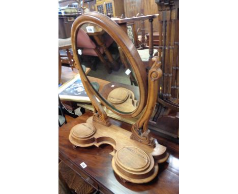 A stained wood platform dressing table mirror with oval plate and flanking lift-top trinket drawers to shaped base