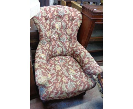 A 19th Century spoon back drawing room armchair with button back floral tapestry upholstery, set on mahogany tulip carved and