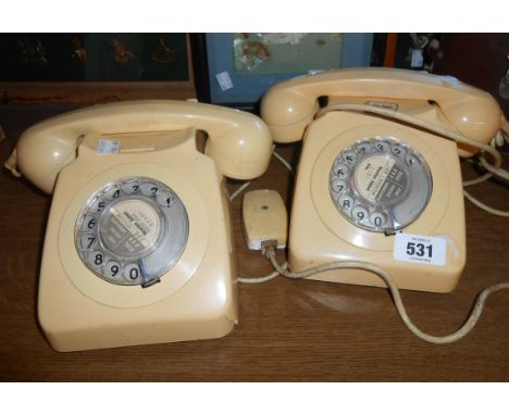 Two vintage telephones in ivory livery