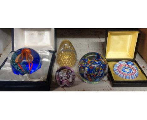 Five glass paperweights comprising Caithness limited edition Accord in original box, smaller Caithness pebbleweight, boxed Pe