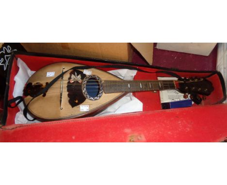 An old mandolin with decorative mother-of-pearl-inlay to sound box contained in original case
