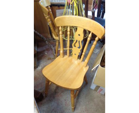 A set of six modern blonde wood Windsor style dining chairs with pierced splat backs, set on ring turned supports