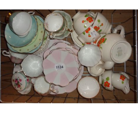 A wire tray containing a quantity of Spode china and other teaware