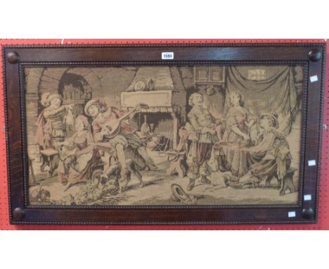 An early 20th Century oak framed tapestry panel, depicting figures in an interior