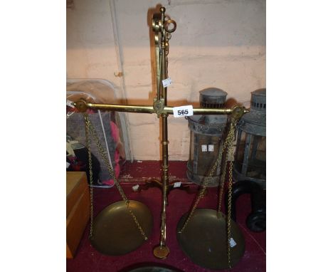 A set of Victorian brass balance scales set on tripod base marked for Degrave, Short, Fanner &amp; Co London