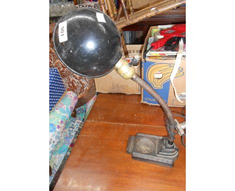 An early 20th Century desk lamp with cast iron base, brass swan neck and painted metal shade