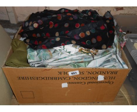 A box containing a quantity of vintage textiles