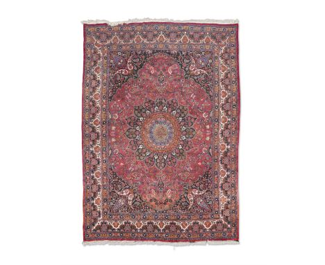 A LARGE SEMI-ANTIQUE PERSIAN RUG, 430 X 310CM,  the central field woven with flowerhead medallion in orange, light blue, navy