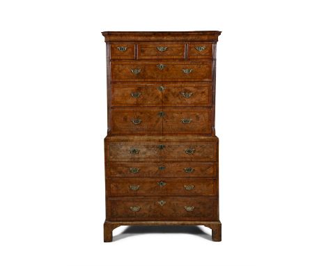 A GEORGE II WALNUT CHEST ON CHEST  with ogee moulded frieze and canted fluted sides, flanking an arrangement of three short a