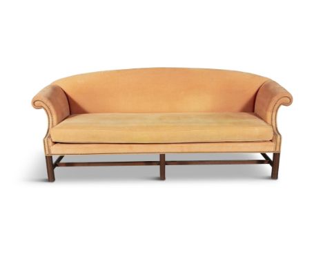 A GEORGIAN REVIVAL MAHOGANY FRAMED THREE SEATER SOFA  with arched padded back and out-scrolling arms covered in a soft tan fa