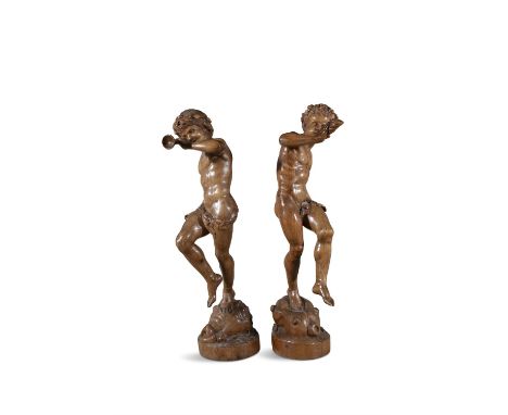 A PAIR OF FRENCH CARVED LIMEWOOD FIGURES OF BACCHIC YOUTH, 19TH CENTURY,  wearing laurel wreathes, one figure playing a bugle
