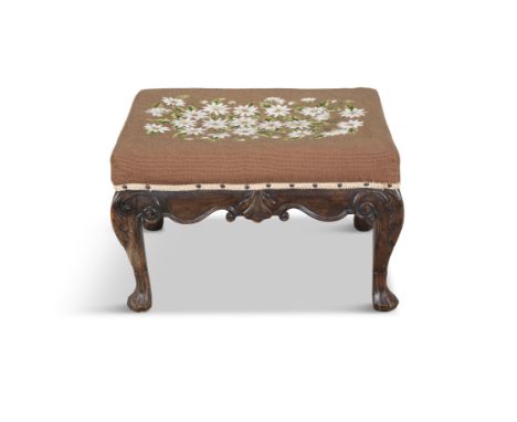 AN IRISH CARVED MAHOGANY STOOL 19TH CENTURY    the rectangular seat covered in a gros-point tapestry, over a shell carved fri