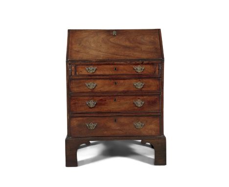 A GEORGE III MAHOGANY COMPACT SLOPEFRONT BUREAU   the fall front top, above four long cockbeaded drawers with brass drop hand