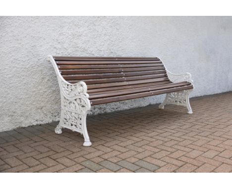 A VICTORIAN CAST IRON GARDEN BENCH, ATTRIBUTED TO COALBROOKDALE   with slatted timber back and seat, pierced foliate sides an